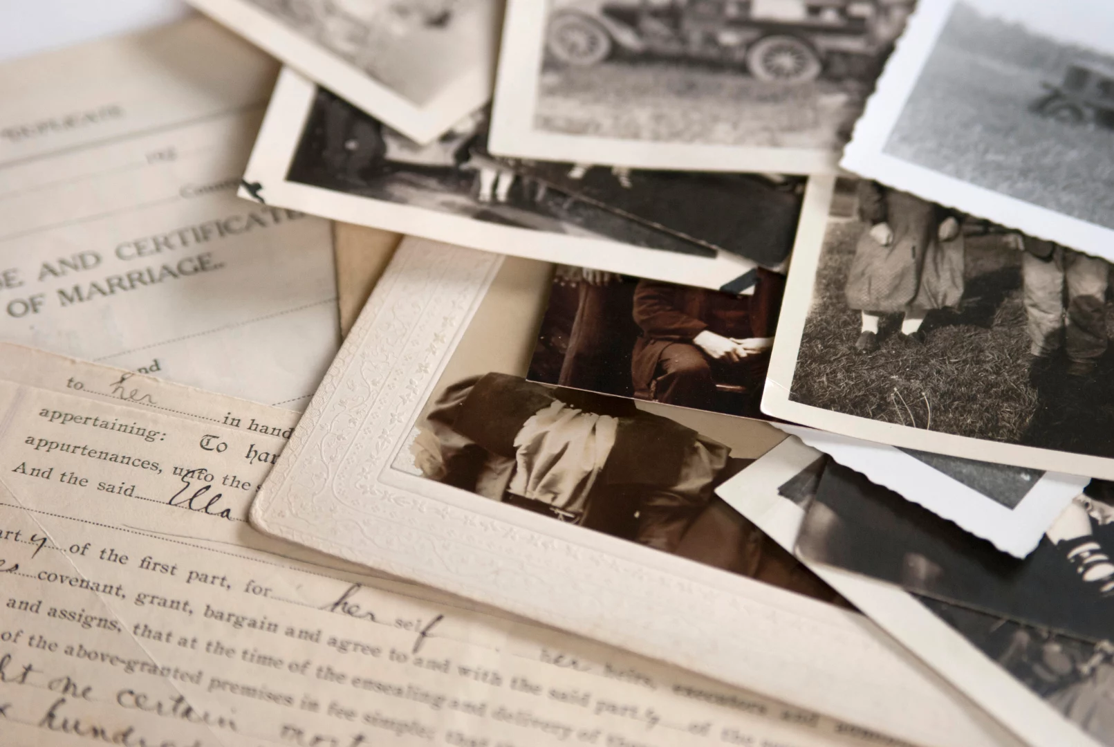 Antique photos and documents piled on top of each other.